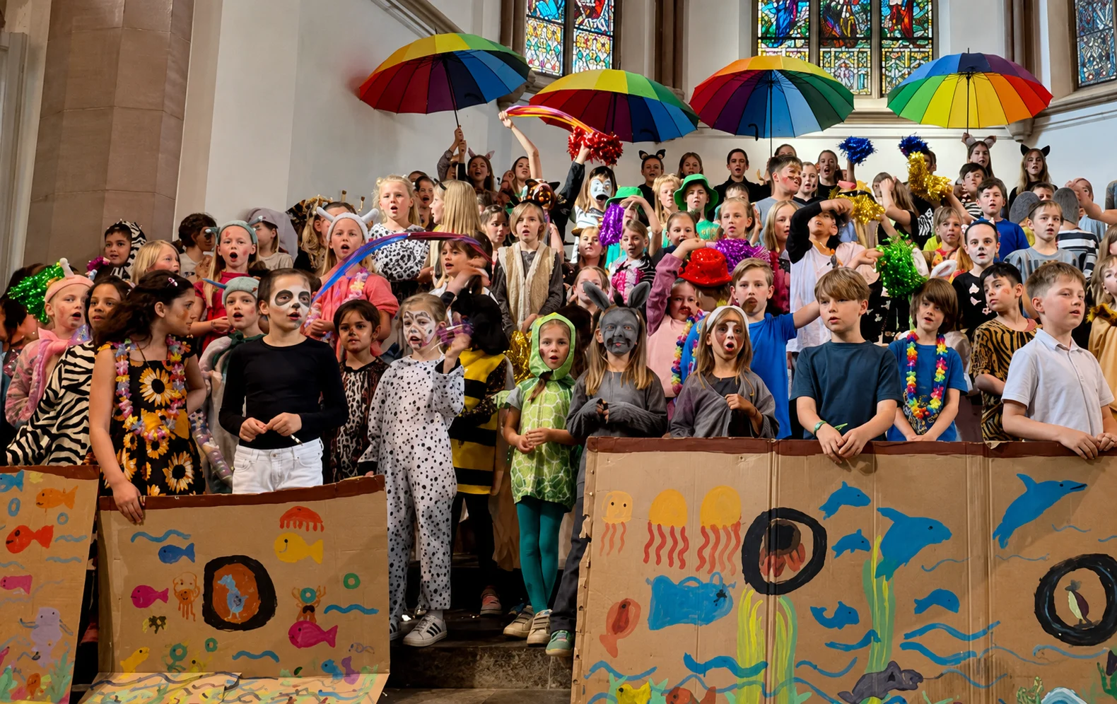 Kinderchor auf der Bühne mit bunten Regenschirmen beim Konzert „A Million Dreams“